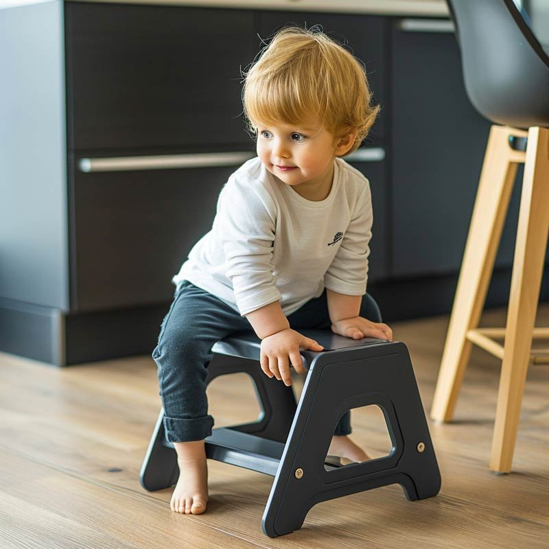 Child boy on a child step stool